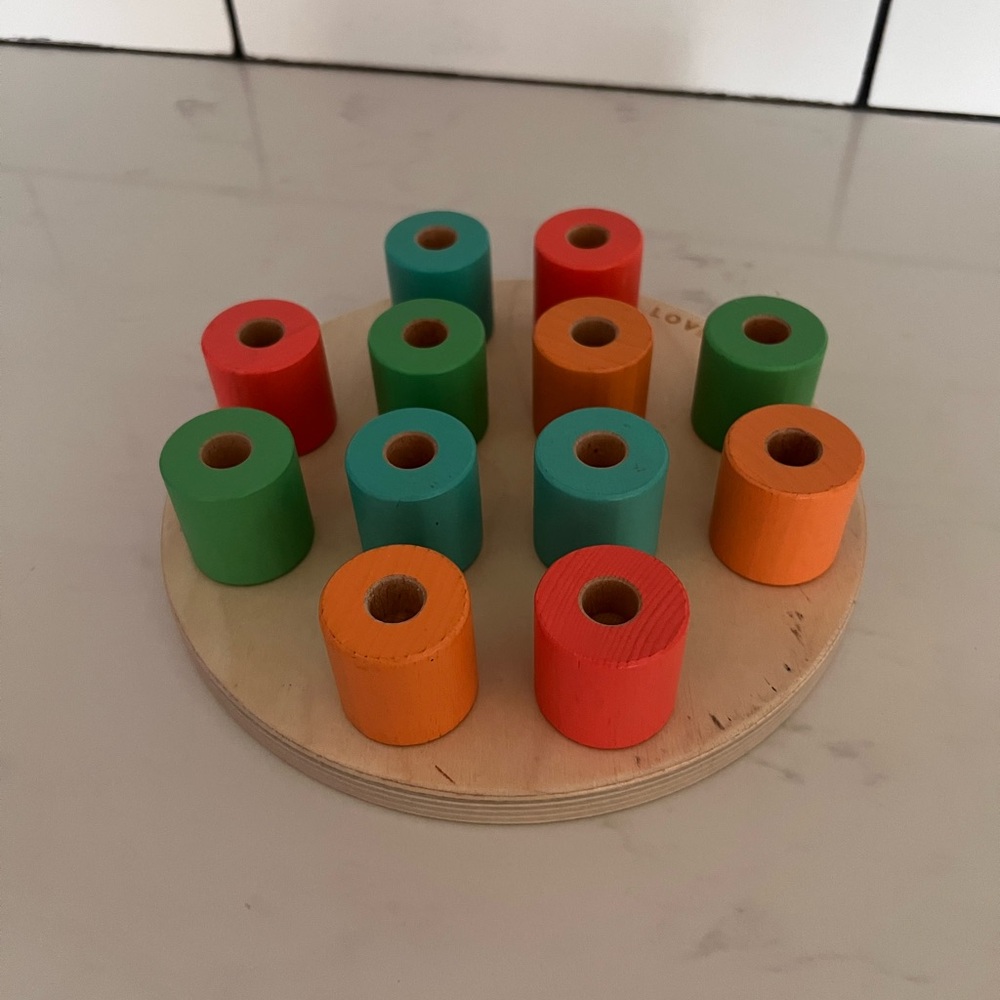 Lovevery wooden stacking peg board with pegs